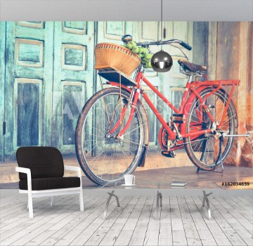 Picture of Hipster red bicycle in old building walls background color if vintage tone 